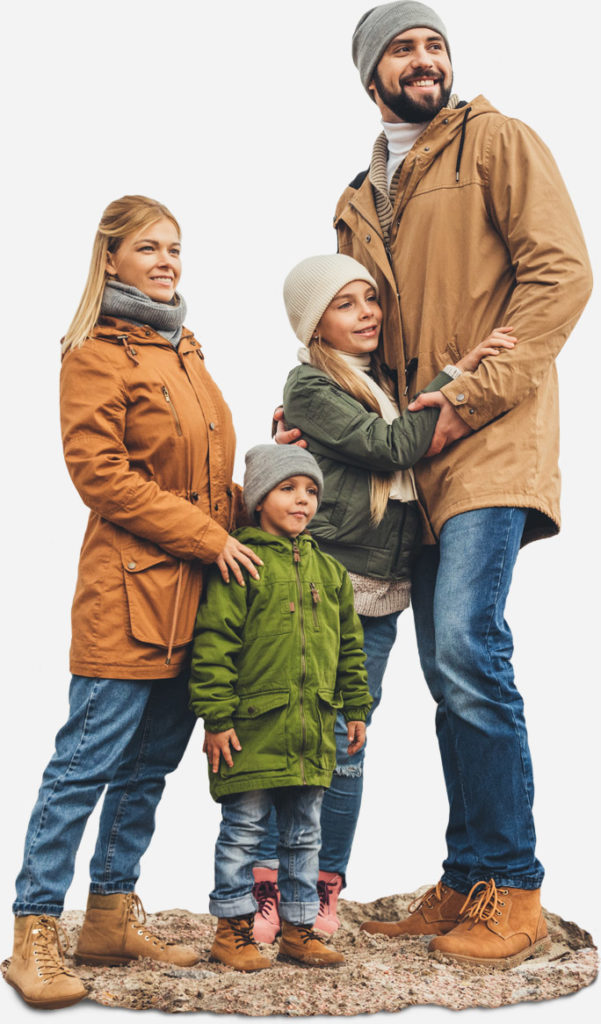 A family smiling outdoors