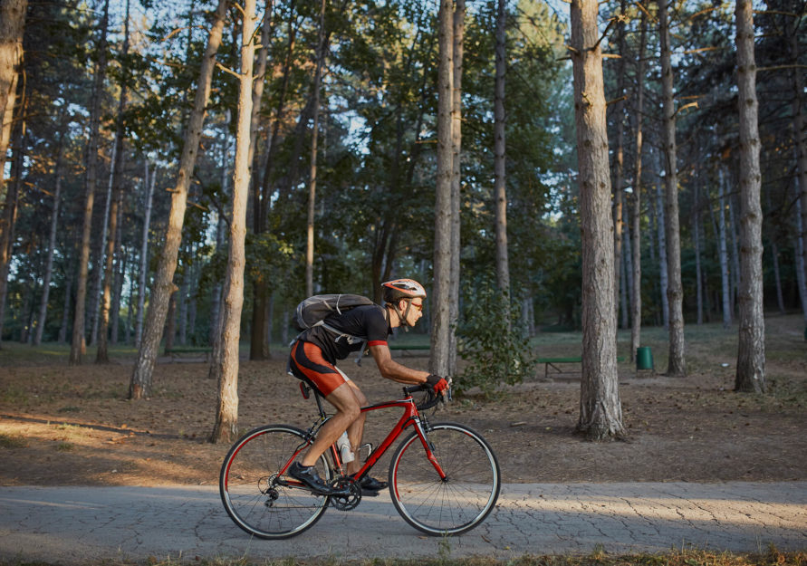 Man riding bike amongst trees