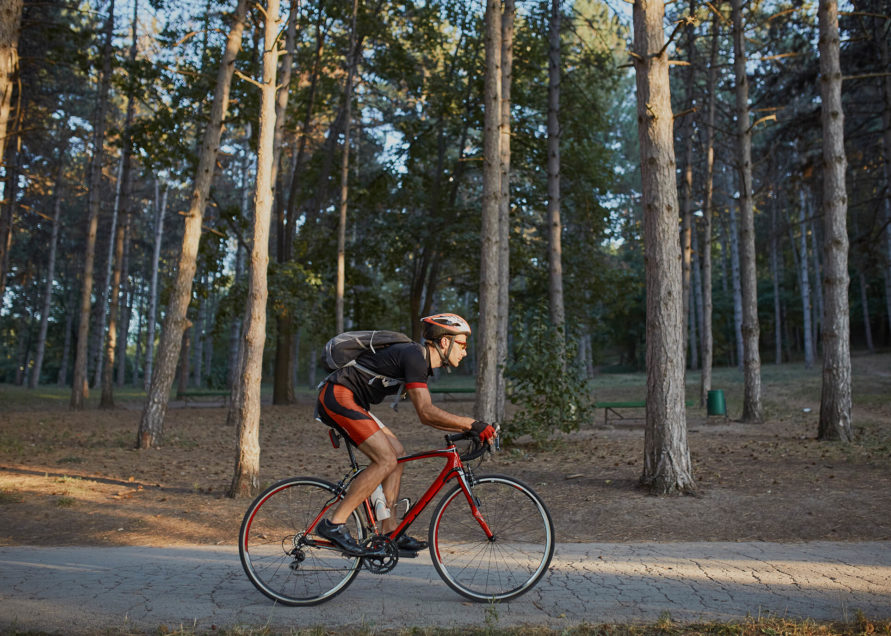 Man riding bike amongst trees