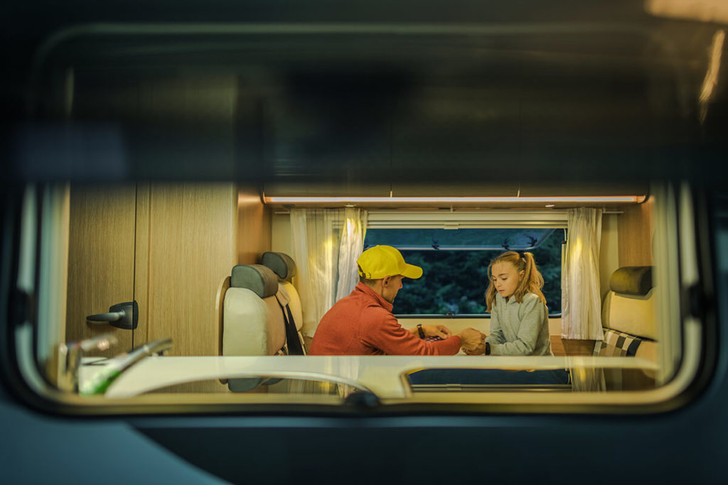 Father and daughter playing game in RV