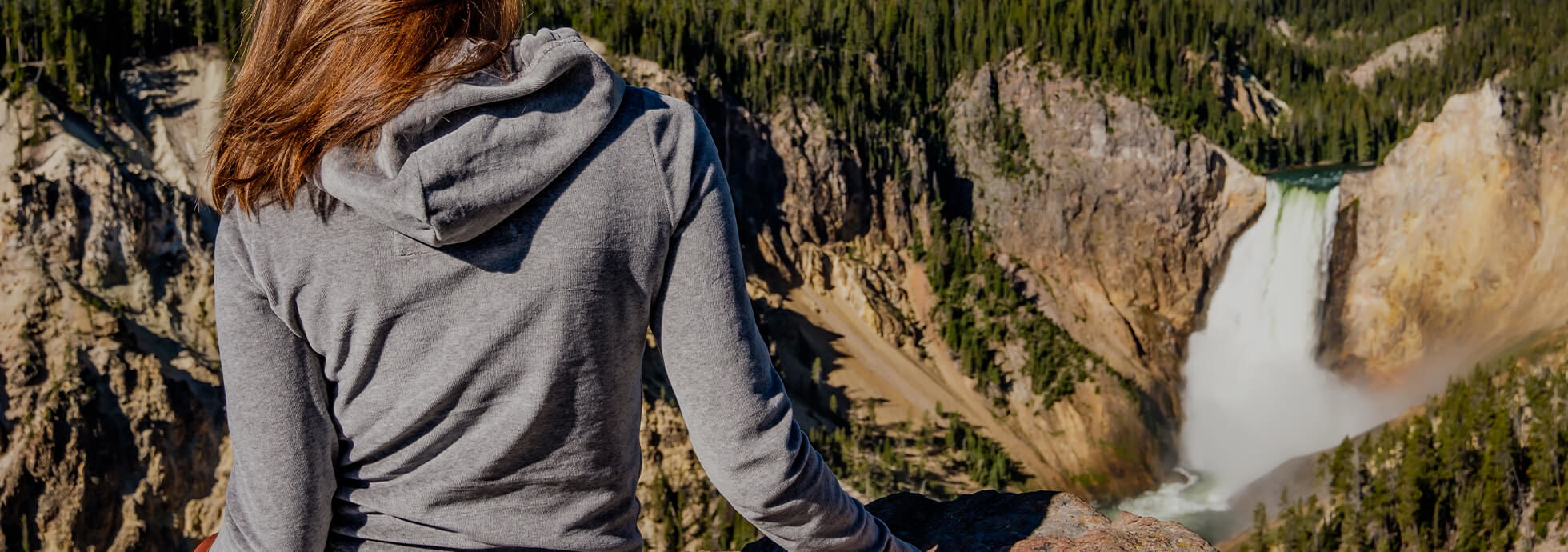 Woman standing over a Yellowstone waterfall